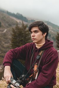 Portrait of young man looking at mountains