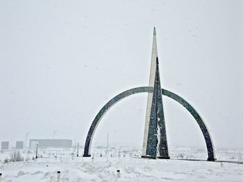 Snow covered structure against sky