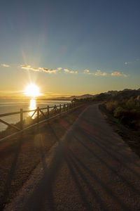 Scenic view of road against sky during sunset