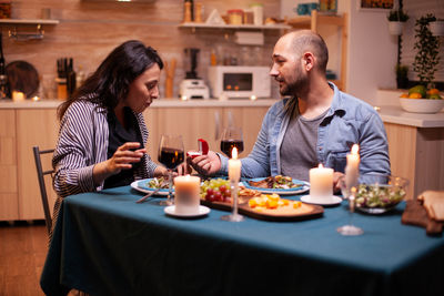 Portrait of young woman having food at home