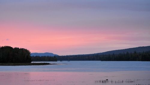 Scenic view of lake against sky during sunset