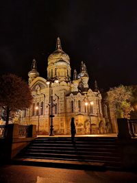 Illuminated building against sky at night