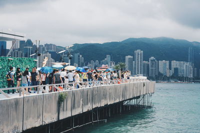 People at observation point against mountains