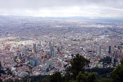 High angle view of cityscape against cloudy sky