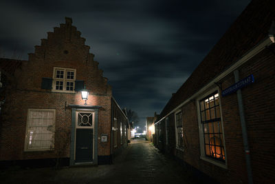 Aluminated houses against night sky