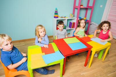 High angle view of cute kids learning at classroom