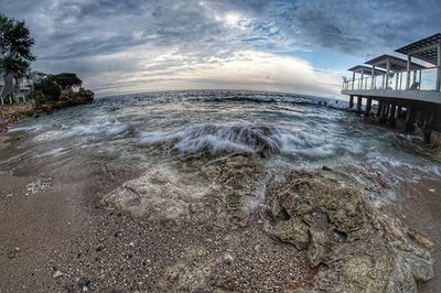 Scenic view of sea against cloudy sky
