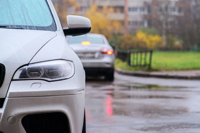 Close-up of wet car on road