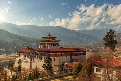 Panoramic view of building and mountains against sky