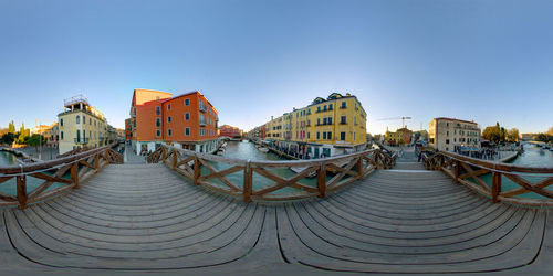 View of cityscape against clear blue sky