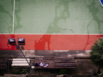 People standing by red wall