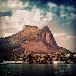 Scenic view of mountains against cloudy sky
