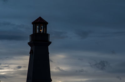 Low angle view of lighthouse against cloudy sky during sunset