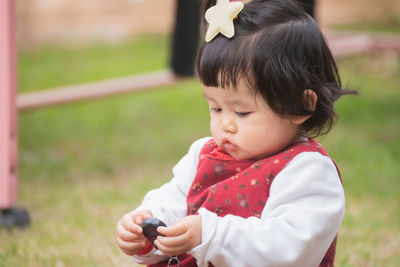 Portrait of cute girl playing outdoors