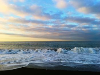 Scenic view of sea against cloudy sky