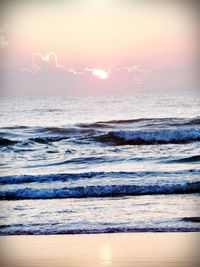 Scenic view of beach against sky during sunset