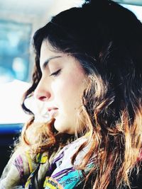 Close-up portrait of young woman looking away