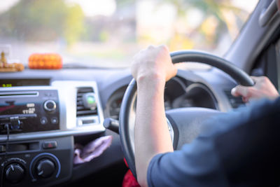 Close-up of man driving car