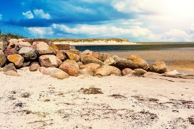 Rocks on beach against sky