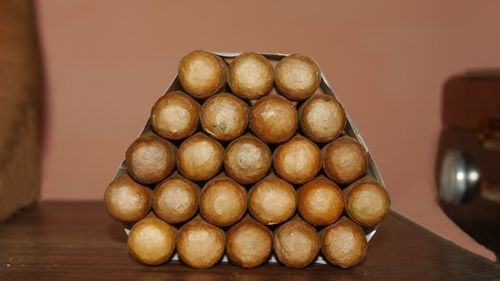 Close-up of stapeled cigars on table