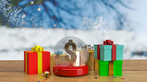Red toys on table against trees during winter