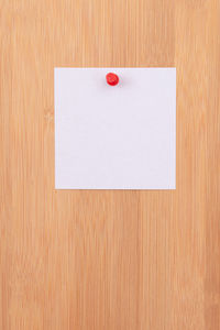 Close-up of white paper on wooden surface