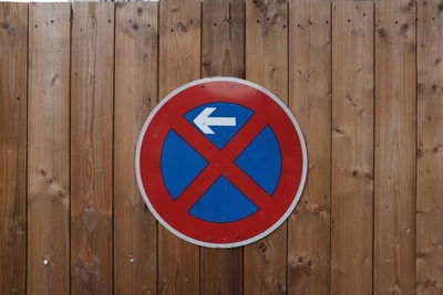 Road sign on wooden fence