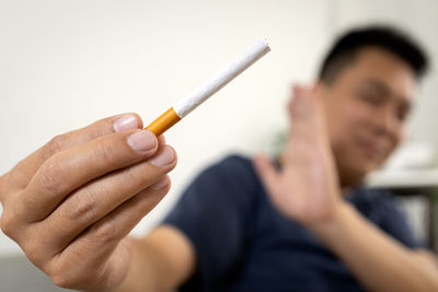 Close-up of man holding pen