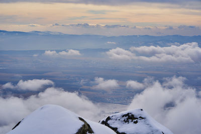 Scenic view of snow covered mountains against sky