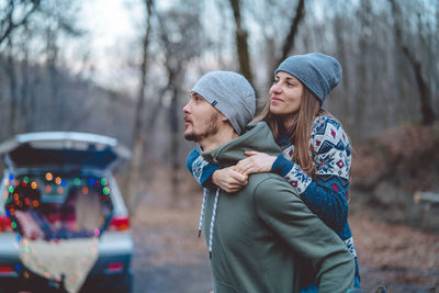 Young couple standing in park during winter