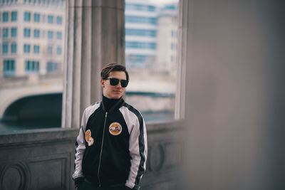 Young man wearing sunglasses standing outdoors