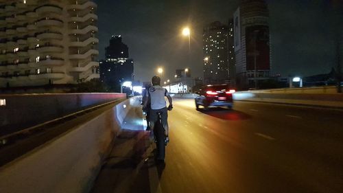 Vehicles on road in city at night