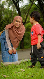 Rear view of father and son on plants
