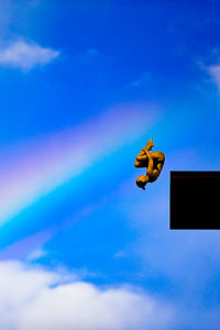 Low angle view of woman with arms outstretched against sky in european championship 2022, high jump