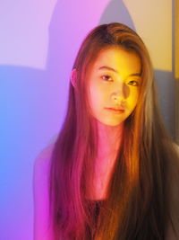 Close-up portrait of a beautiful young woman at home