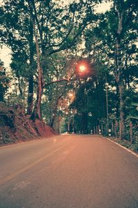 Road amidst trees against sky