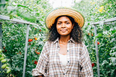 Young woman standing amidst plants