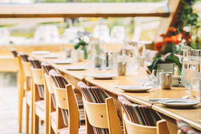 Empty chairs and tables in restaurant