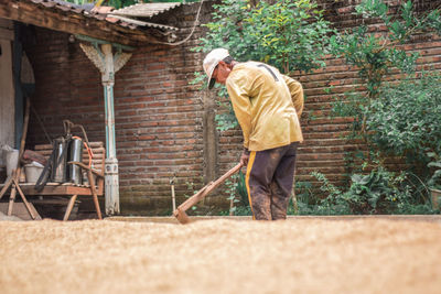 Side view of man working at farm