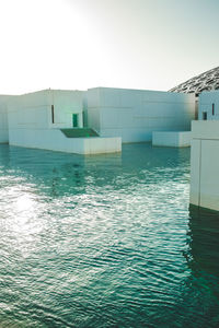 Swimming pool by building against clear sky