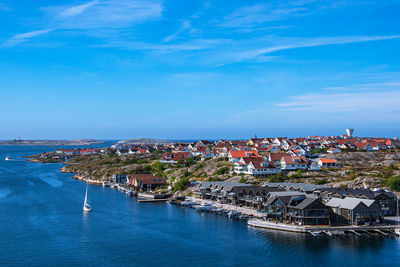 High angle view of townscape by sea against sky