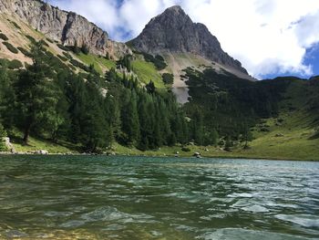 Scenic view of lake and mountains against sky