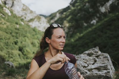 Portrait of woman standing on rock