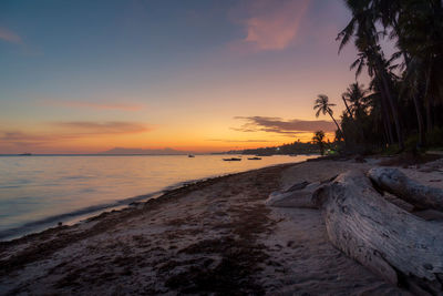 Scenic view of beach against sky during sunset