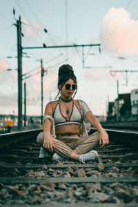 Woman wearing sunglasses sitting outdoors