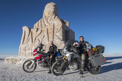 Two men and their touring motorbike's on the salt flats of uyuni