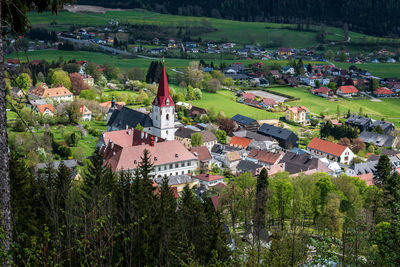 High angle view of houses and trees on field