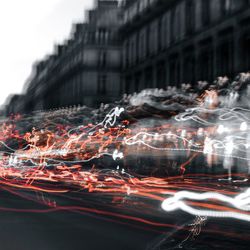 Blurred motion of light trails on building in city