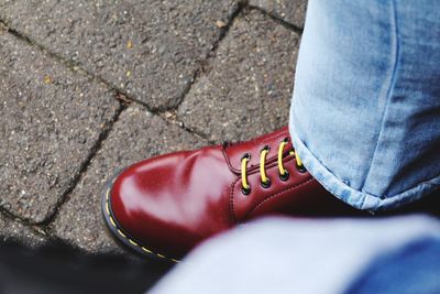 Low section of person wearing red shoes