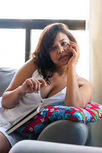 Portrait of a young woman sitting at home